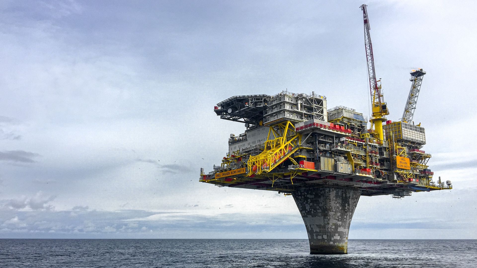 Dramatic view of a large oil platform in Norway's North Sea, symbolizing offshore industry.