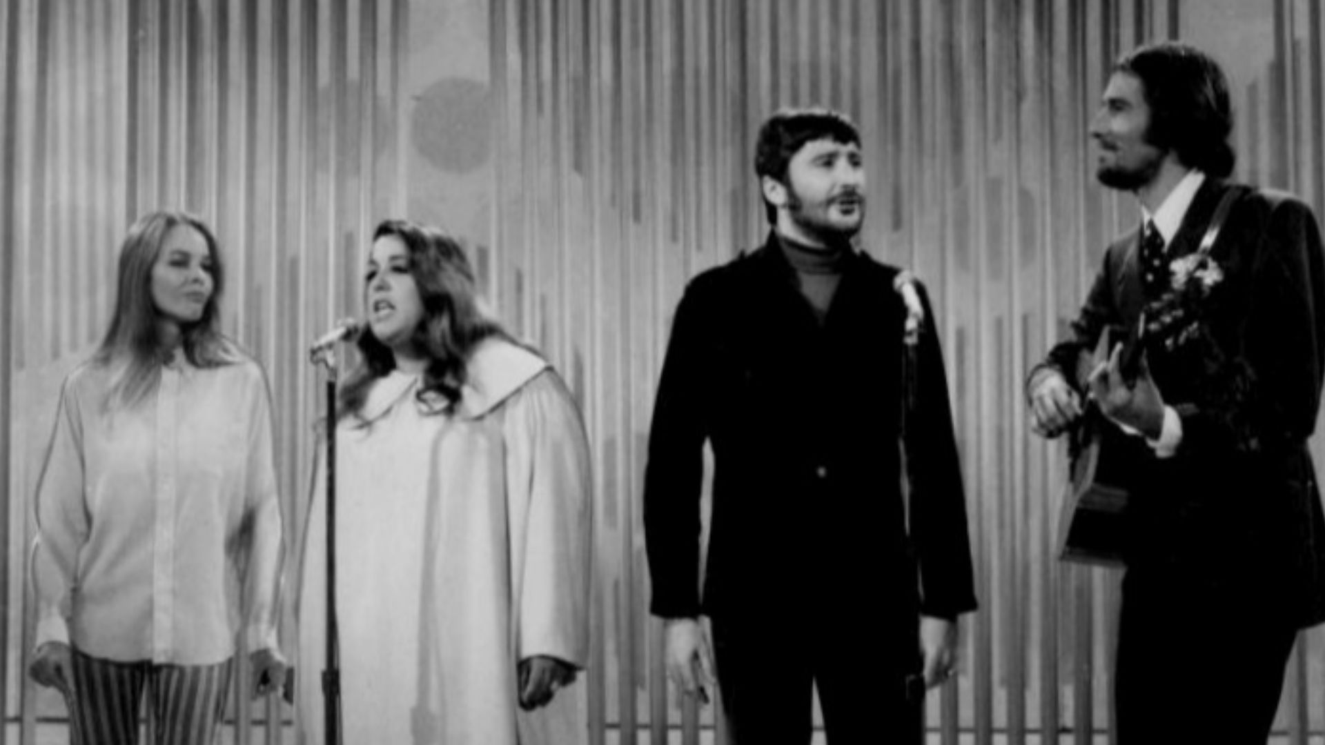 Photo of The Mamas and the Papas performing on The Ed Sullivan Show. From left-Michelle Phillips, Cass Elliot, Denny Doherty, and John Phillips.