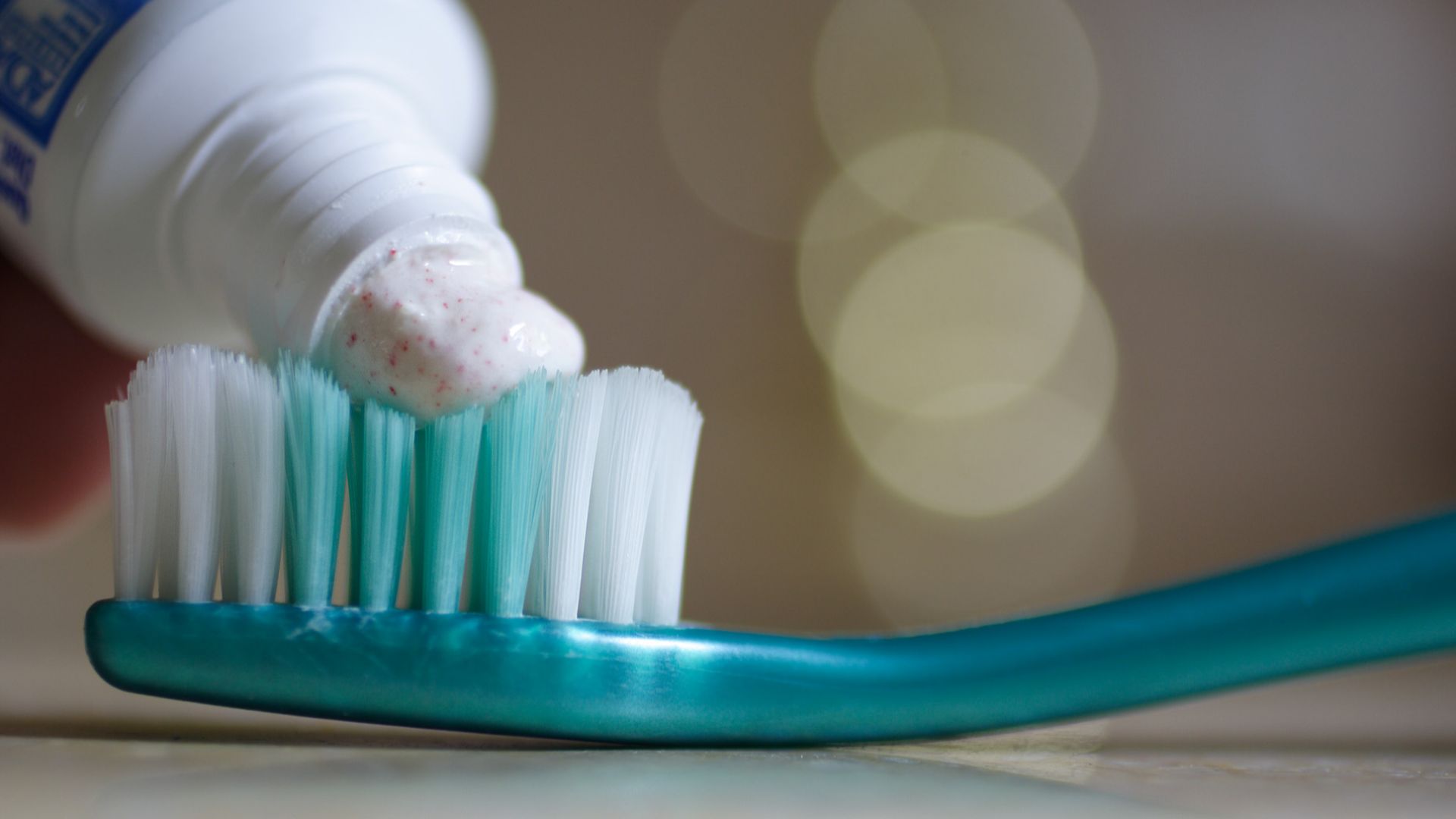 Putting toothpaste on a toothbrush. The toothpaste is Crest Pro-Health Clean Cinnamon, 0.454% stannous fluoride, 0.16% w/v fluoride ion.