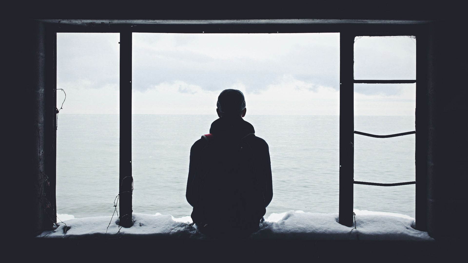 person looking out through window