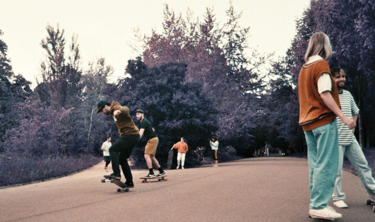 Teens enjoying skateboarding in a vibrant park atmosphere