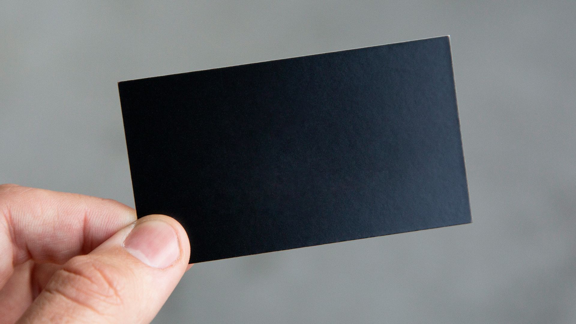 person holding black rectangular paper
