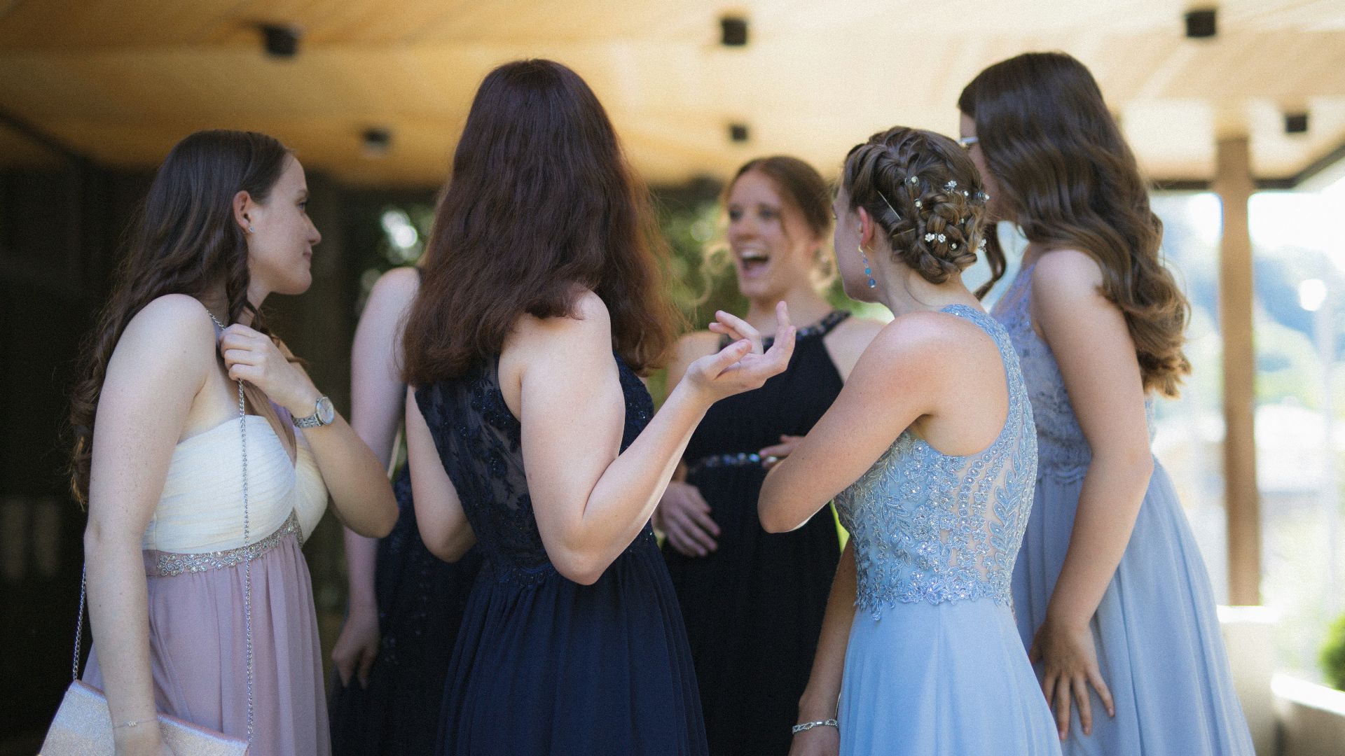 woman in black dress standing in front of woman in white dress