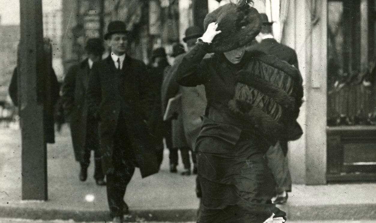 From The Archive: Tremont Street Through The Years BOSTON - DECEMBER: Holding onto her large beaver hat and using her generous shirred satin with its bands of fur as a shield, a woman crosses at the corner of Tremont and Avery Streets in the winter of 1910.