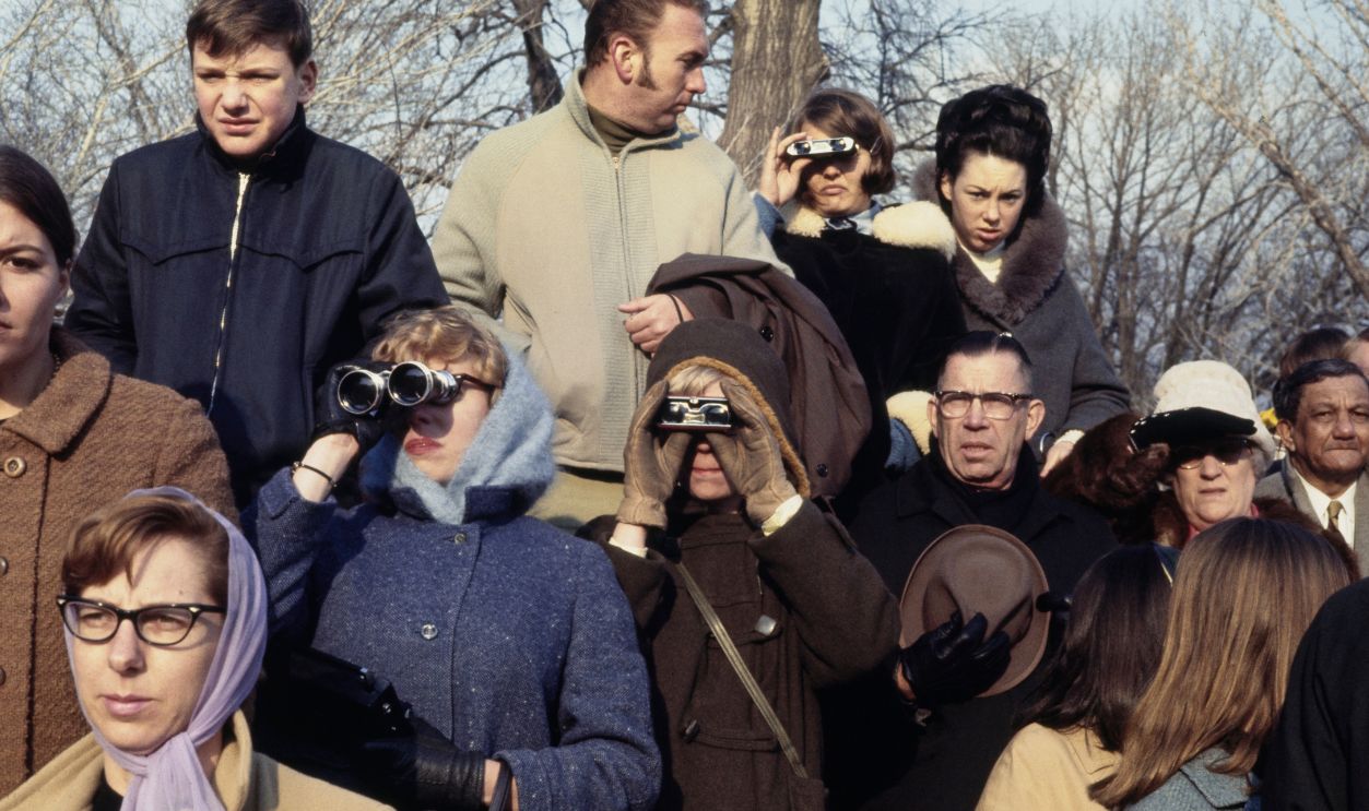 Eisenhower Funeral Procession People watching through binoculars as a military procession takes the coffin of former President Dwight D Eisenhower to the US Capitol in Washington, March 30th 1969.