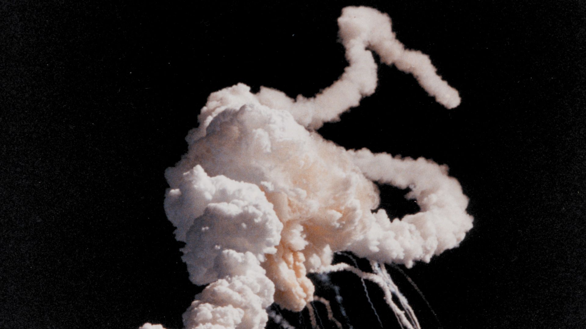 Short Description: Space Shuttle Challenger explodes shortly after take-off.
Full Description: On January 28, 1986, the Challenger space shuttle and her seven-member crew were lost when a ruptured O-ring in the right solid rocket booster caused an explosi