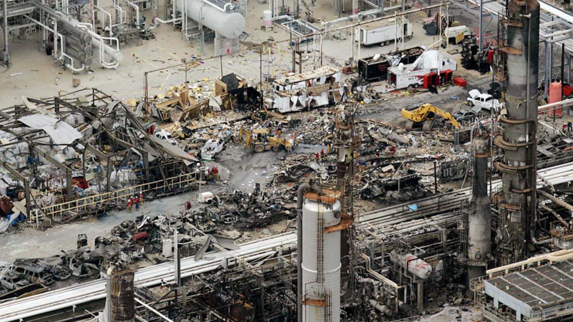 Destroyed trailer west of the isomerization unit in the aftermath of the 2005 BP Texas City refinery explosion. ISOM unit process equipment visible at lower right