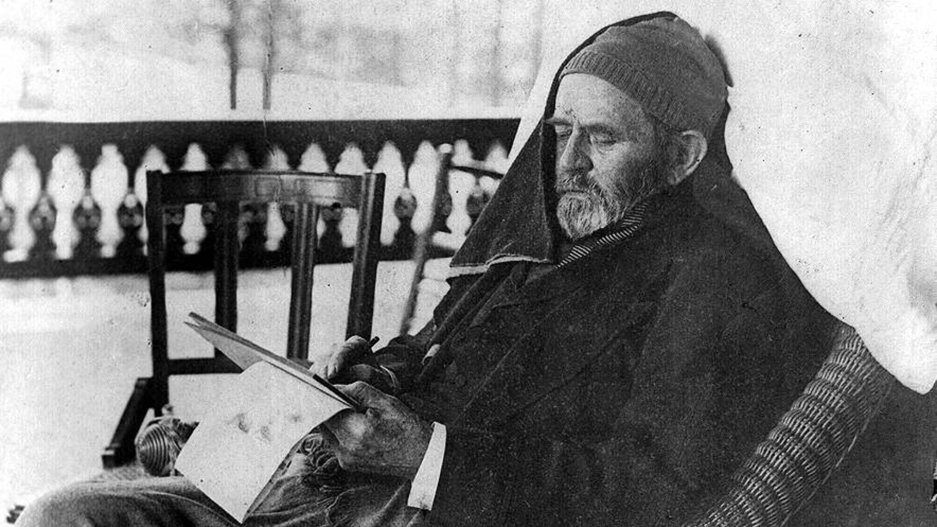 Ulysses Grant, three-quarter length portrait, seated in rattan chair, writing memoirs, at Mount McGregor near Saratoga Springs, N.Y.