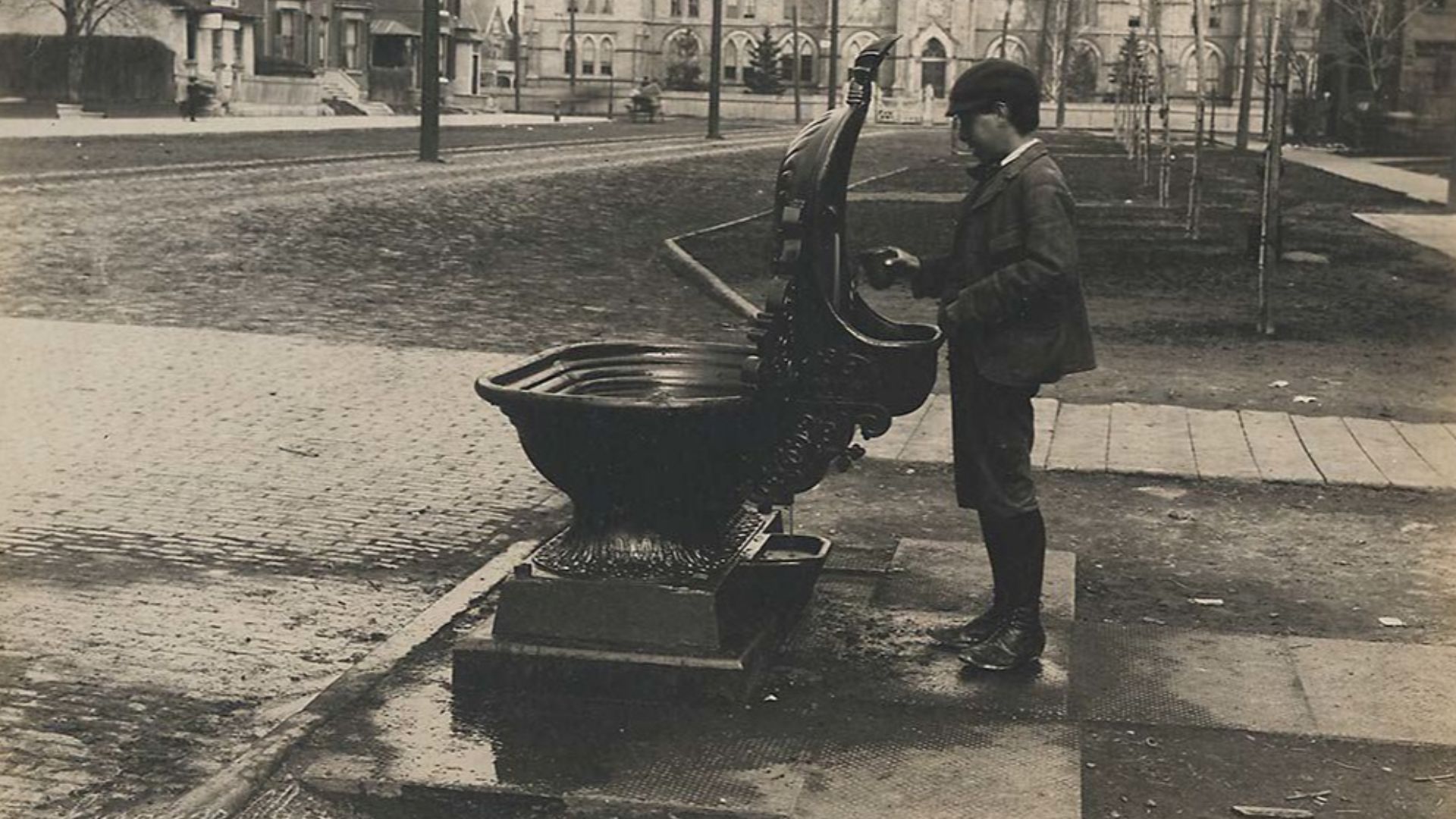 Commissioned by the City Engineer and taken by F.W. Micklethwaite, image shows a drinking fountain at College Street and Spadina Avenue, Toronto, Ontario, Canada.  Fountains such as this, designed to accomodate horses on one side and people on the other, 