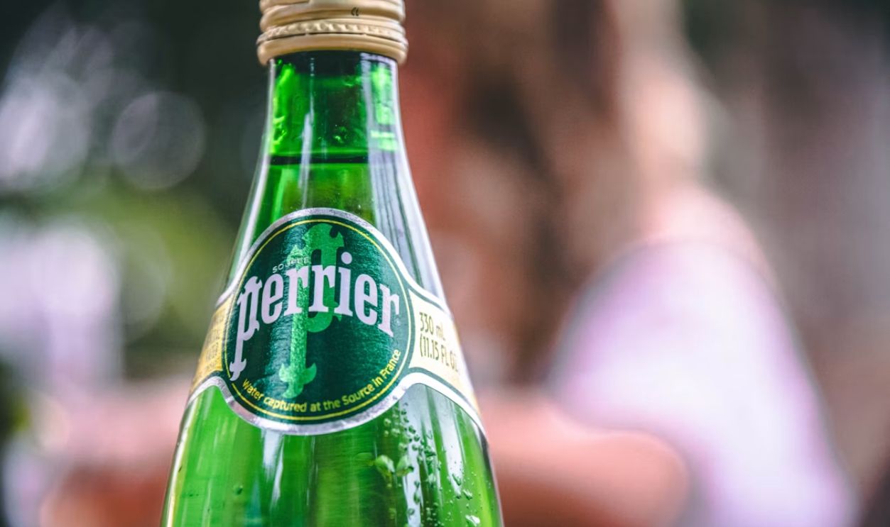 Perrier Bottle With Water Dripping down the side of it