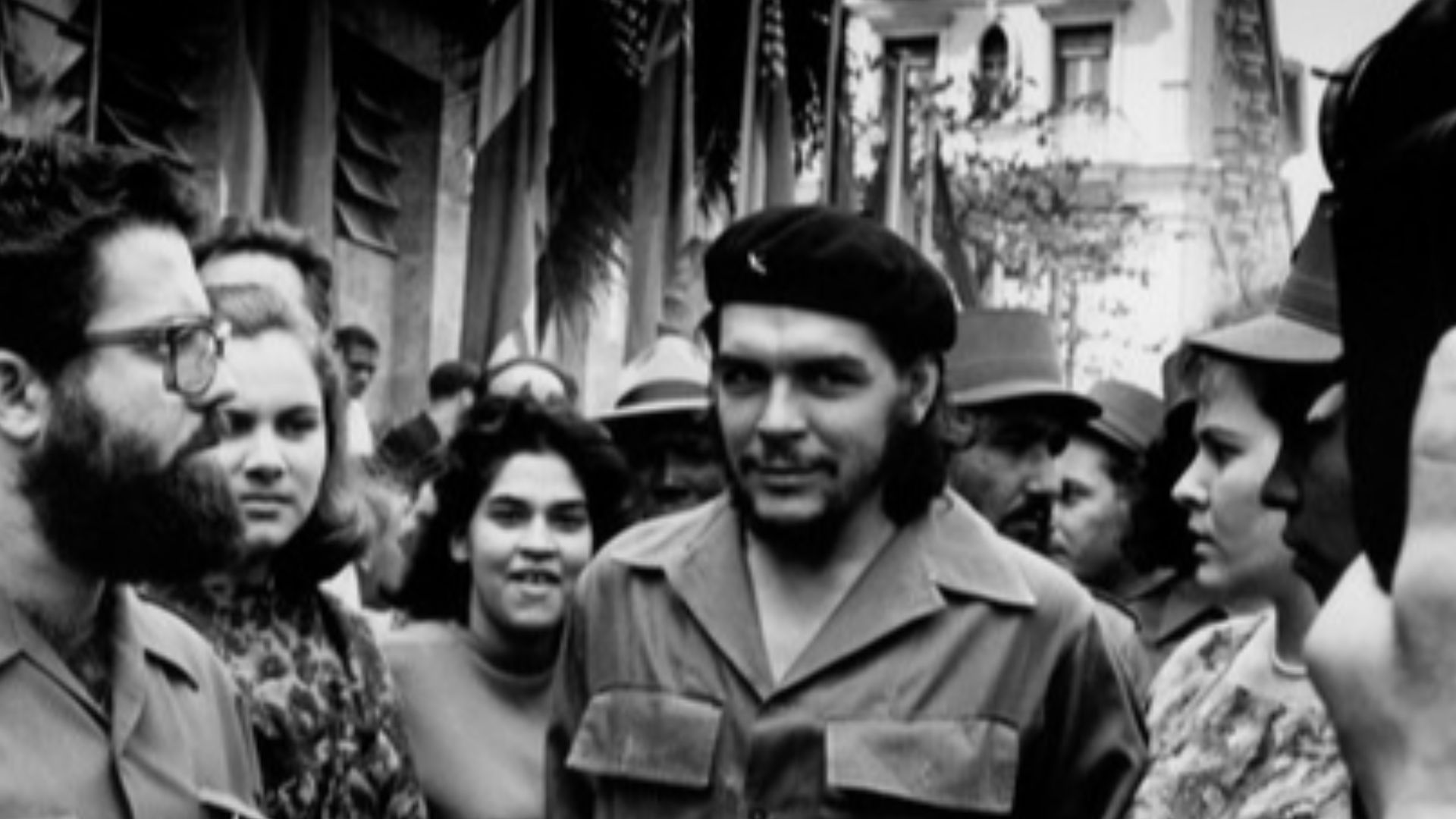 Alberto Korda taking a picture of Che Guevara walking through a throng of cameramen down the streets in Havana, Cuba, with arms linked to his wife Aleida March.