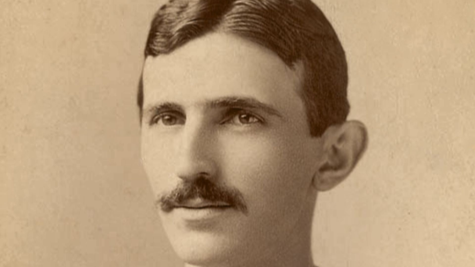 Cabinet photo of Tesla in a head-and-shoulders pose, signed and inscribed in the lower left in black ink, “To Gaston Tissandier, with sincere regards, from Nikola Tesla.”