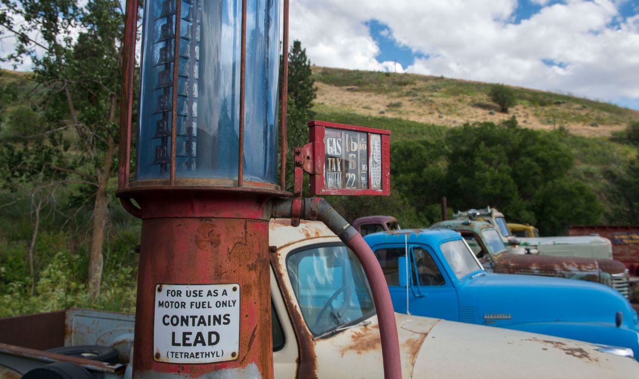 Antique gas pump and cars at an old gas station, part of an WASHINGTON, UNITED STATES - 2015/06/22: Antique gas pump and cars at an old gas station, part of an old car collection at a farm near Colfax in Whitman County in the Palouse, Washington State, USA. 