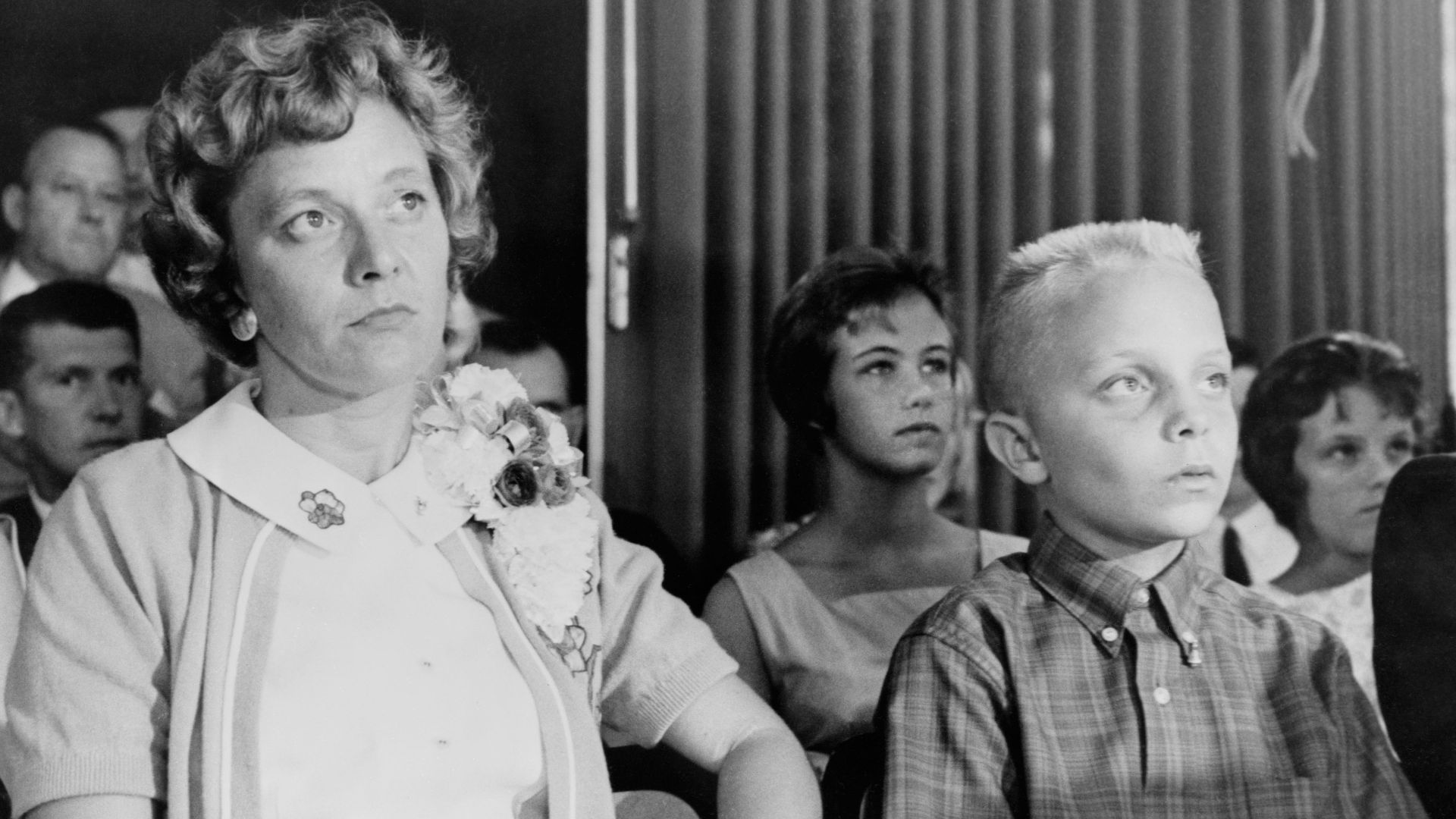 Astronaut Virgil I. (Gus) Grissom's wife and son watch from the audience as a press conference is held on July 23, 1961 at the Starlight motel.