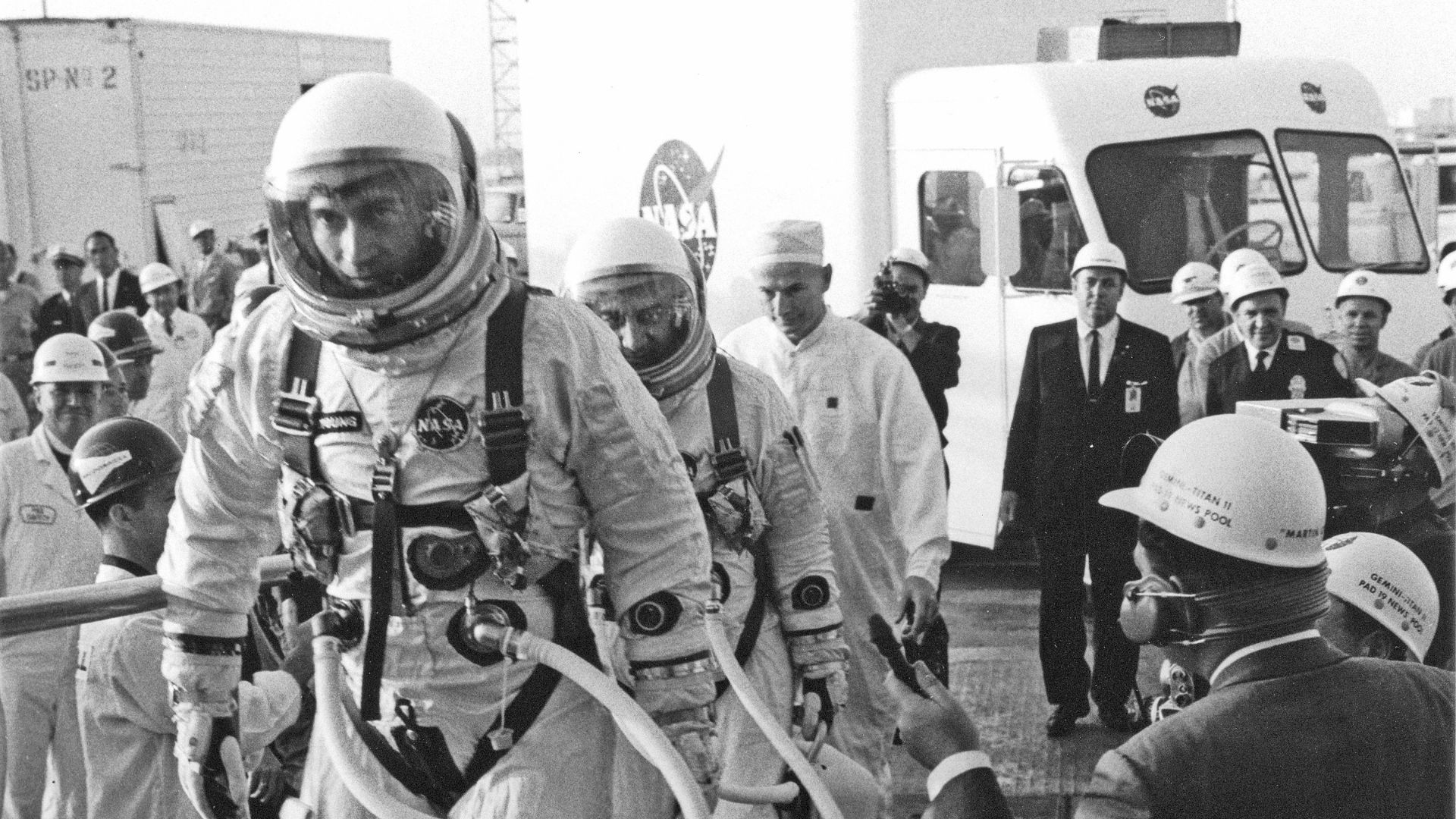 CAPE KENNEDY, Fla. -- At Cape Kennedy Air Force Station in Florida, Gemini 3 pilot John W. Young is followed by command pilot Virgil I. Grissom as they walk to elevator at Launch Complex 19 for their three orbit flight, the first mission of the Gemini spa