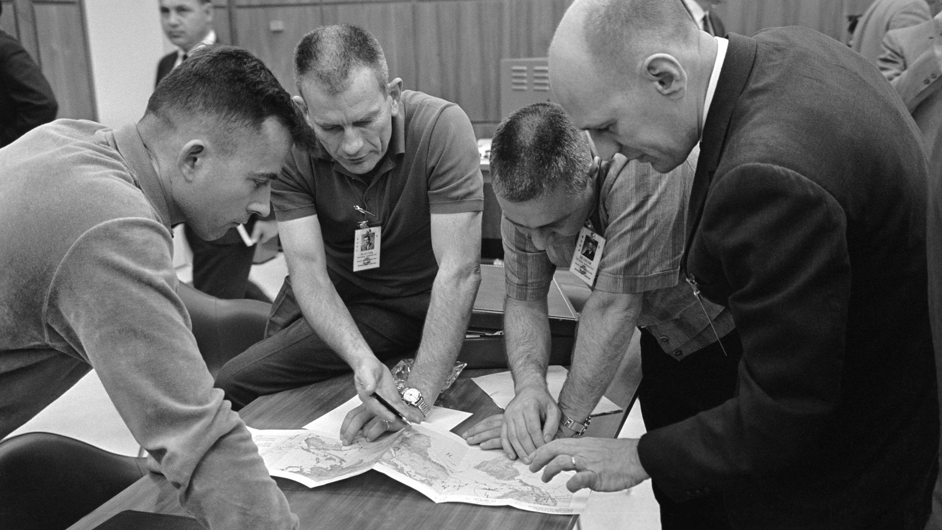S65-20627 (20 March 1965) --- Crew members for the NASA Gemini-Titan 3 mission go over the map of the orbital track with Donald K. Slayton, assistant director for Flight Crew Operations, Manned Spacecraft Center. Shown (left to right) are astronauts John 