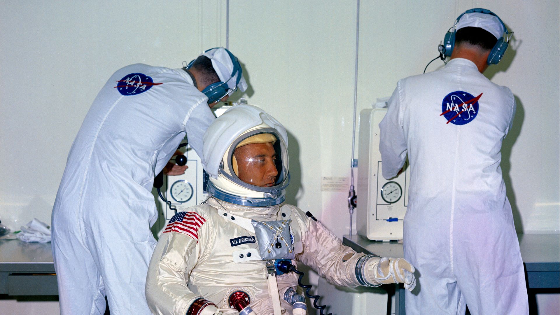 S66-58023 (1966) --- NASA suit technicians assist Astronaut Virgil I. Grissom during suiting operations prior to tests at Kennedy Space Center (KSC). Grissom and other members of the Apollo 204 Prime Crew went through spacecraft simulations inside the Cen