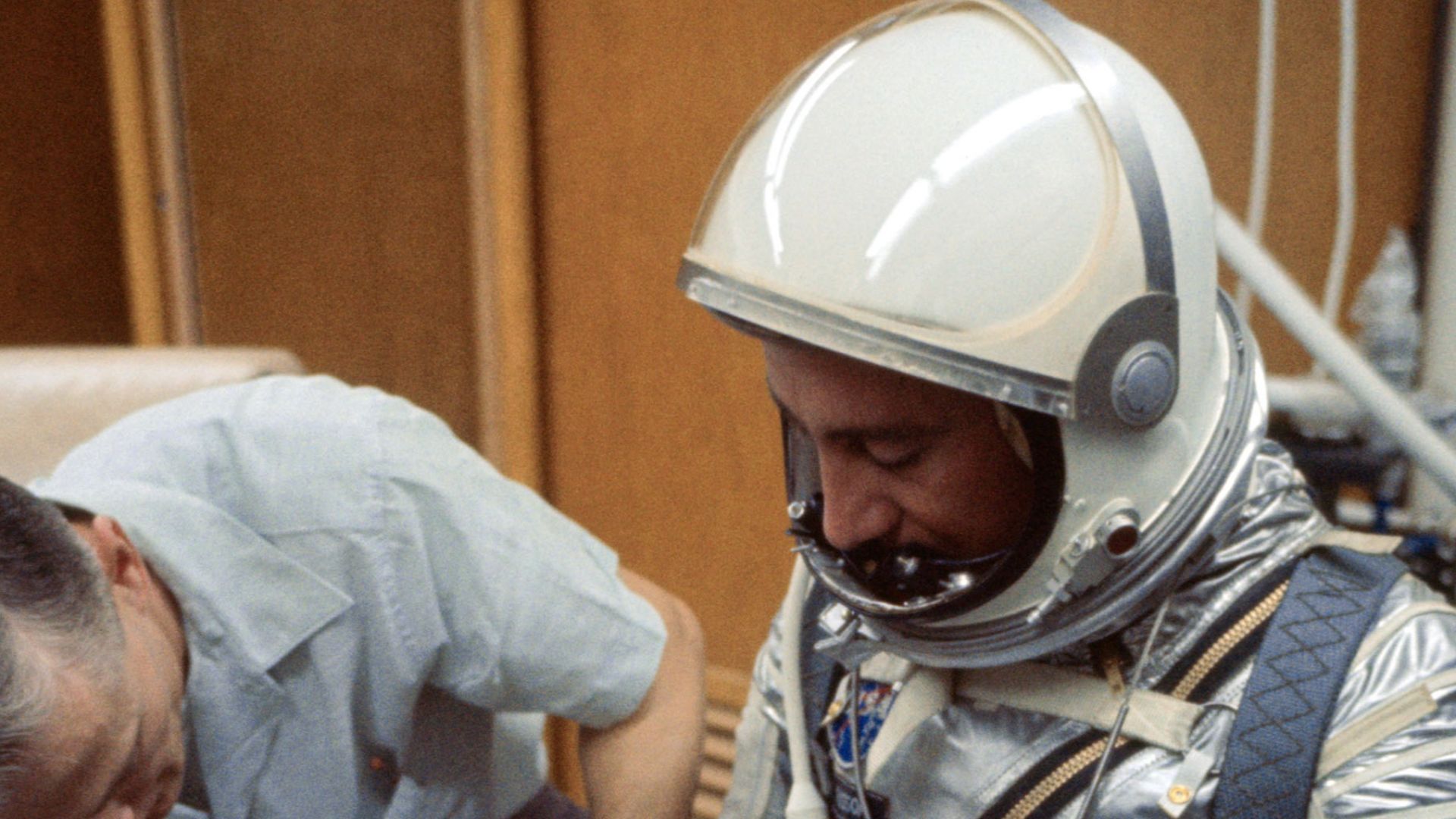 S64-36915 (1961) --- A NASA suit technician adjusts astronaut Virgil I. (Gus) Grissom's Mercury pressure suit during prelaunch activities at the Florida Space Center.