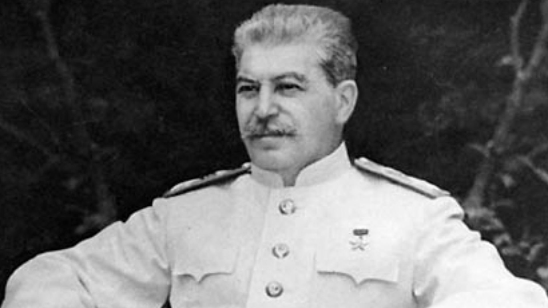 Joseph Stalin, seated outdoors at Berlin conference
