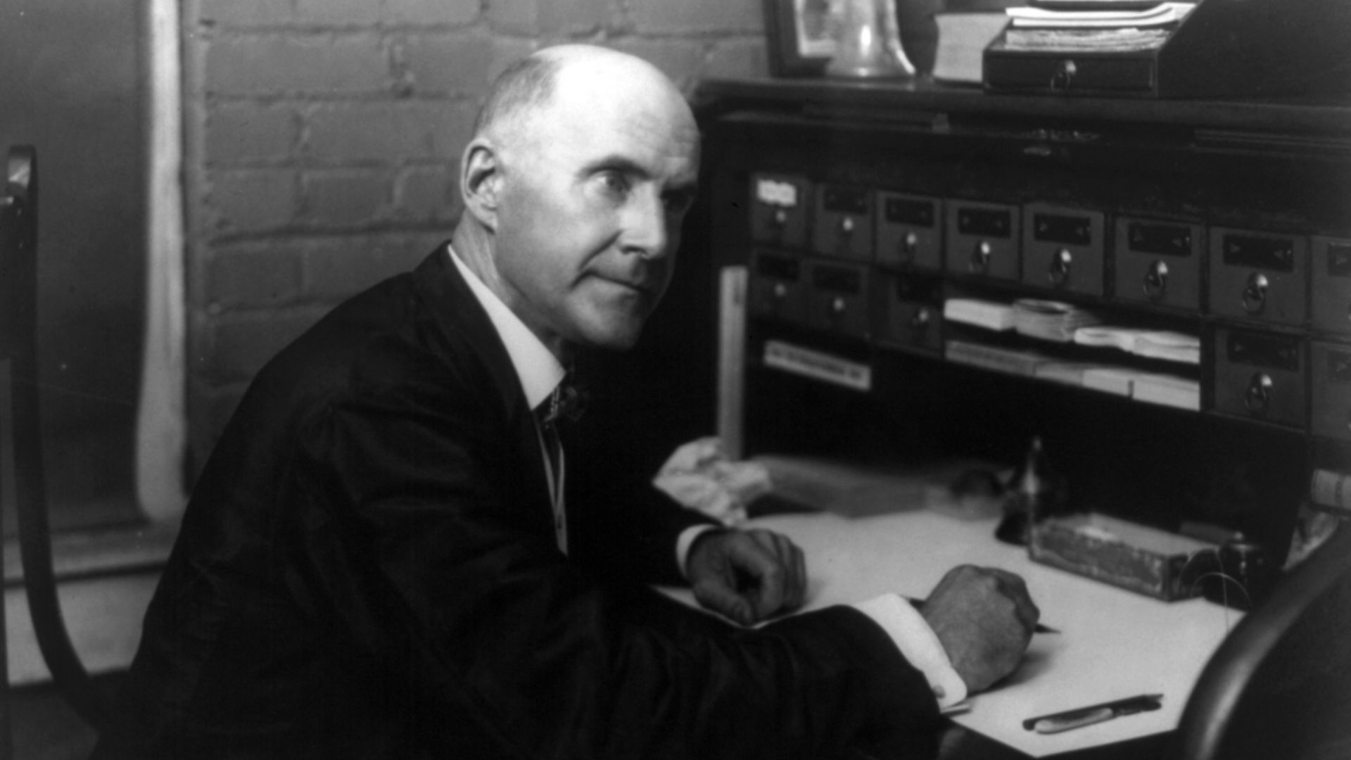 Eugene V. Debs, seated at desk