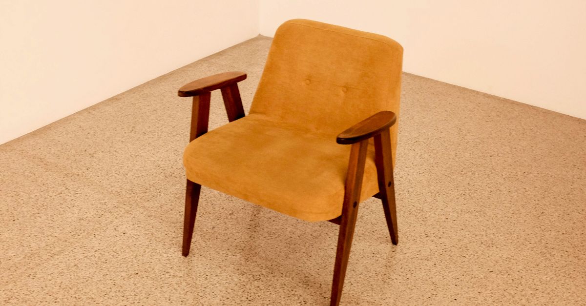 brown wooden framed beige padded chair