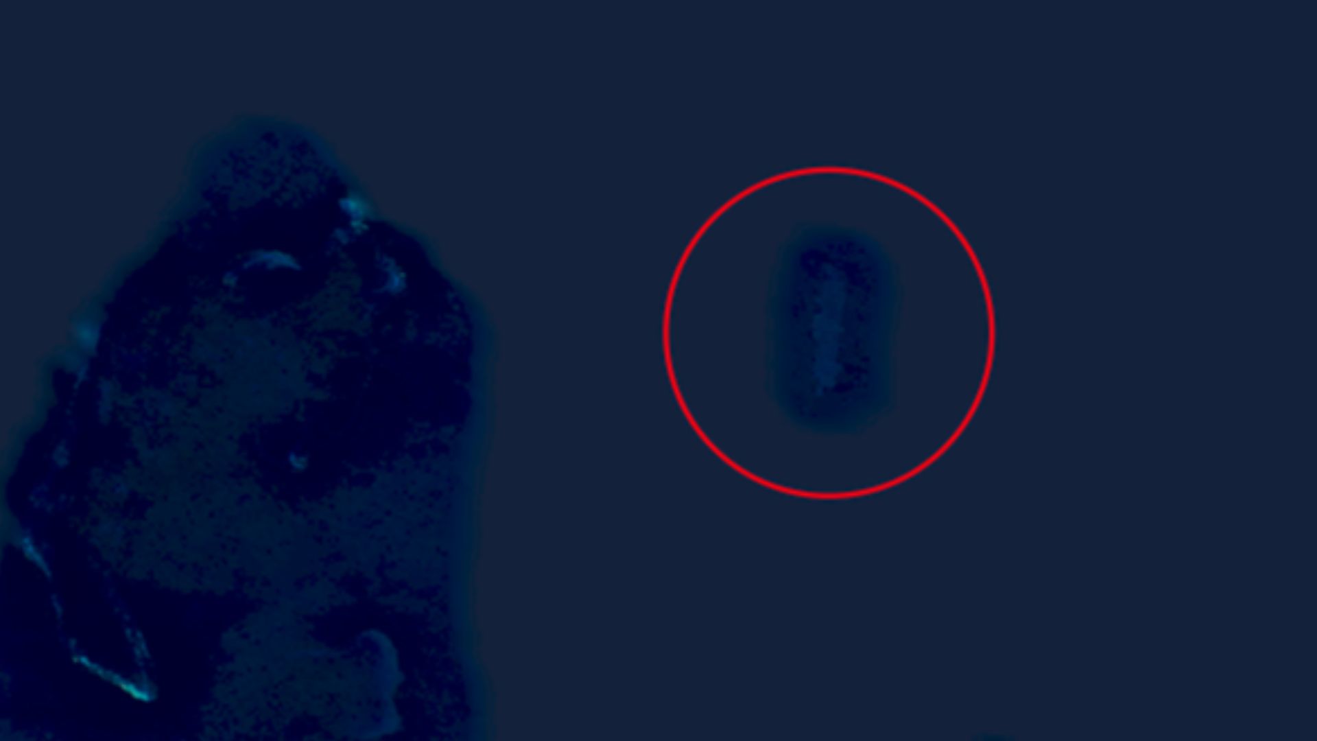 The circled area is “Sandy Island”. The reefs to the left are the Chesterfields. This clearly shows shallow water or a large sand bar.