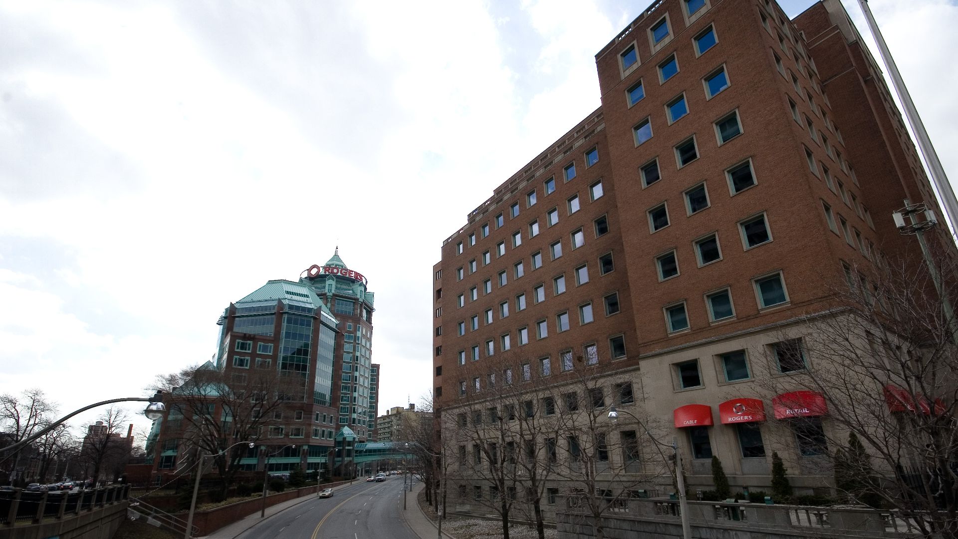 The Rogers Building in Toronto, consisting of a 1950s heritage building on Bloor Street and a 1990s postmodern building on Jarvis Street, connected by a skywalk over Mount Pleasant Road.
