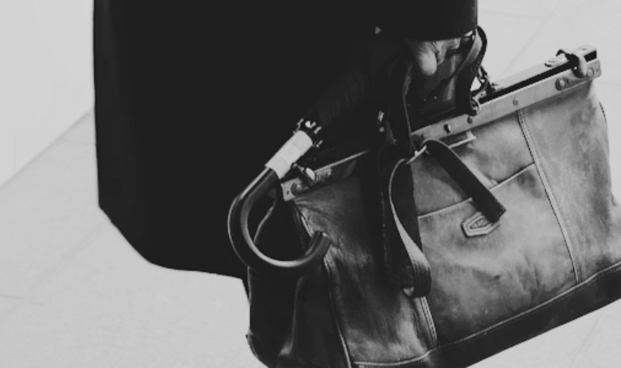 man with bag and umbrella