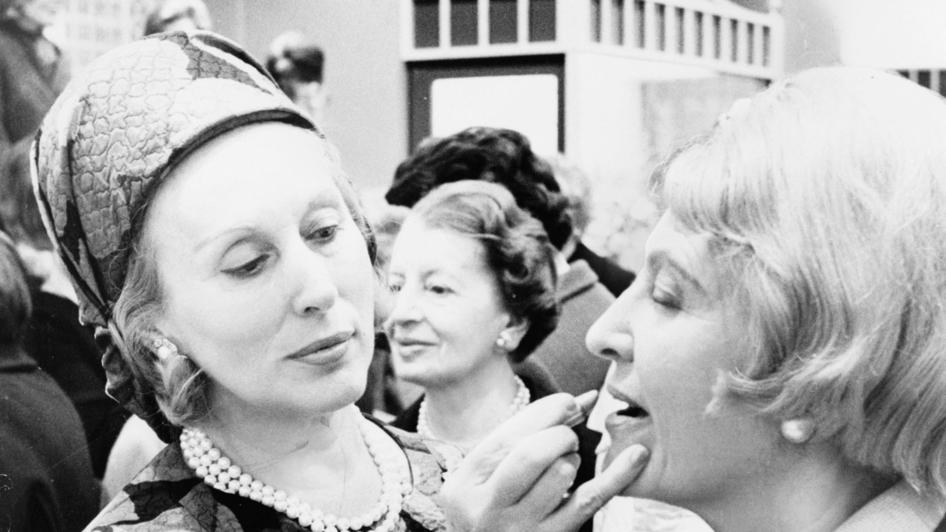 Estee Lauder, in a vivid print from Yves Saint Laurent, puts today's face on customer by using darker shade of lipstick / World Journal Tribune photo by Bill Sauro.