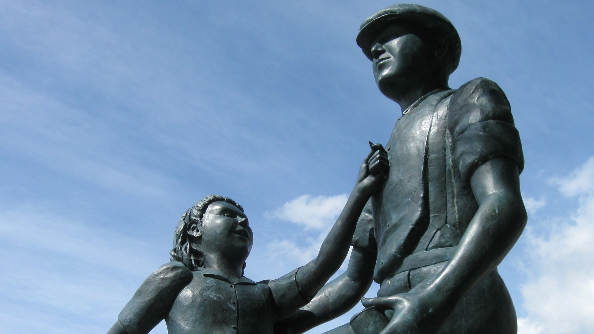 This statue commemorates Mudlarks in Portsmouth, England. Mudlarks would scramble in the mud at the shore to retrieve coins thrown by passerbys. The children who both spend the coins and take them home to their families.
The statue was paid for by private