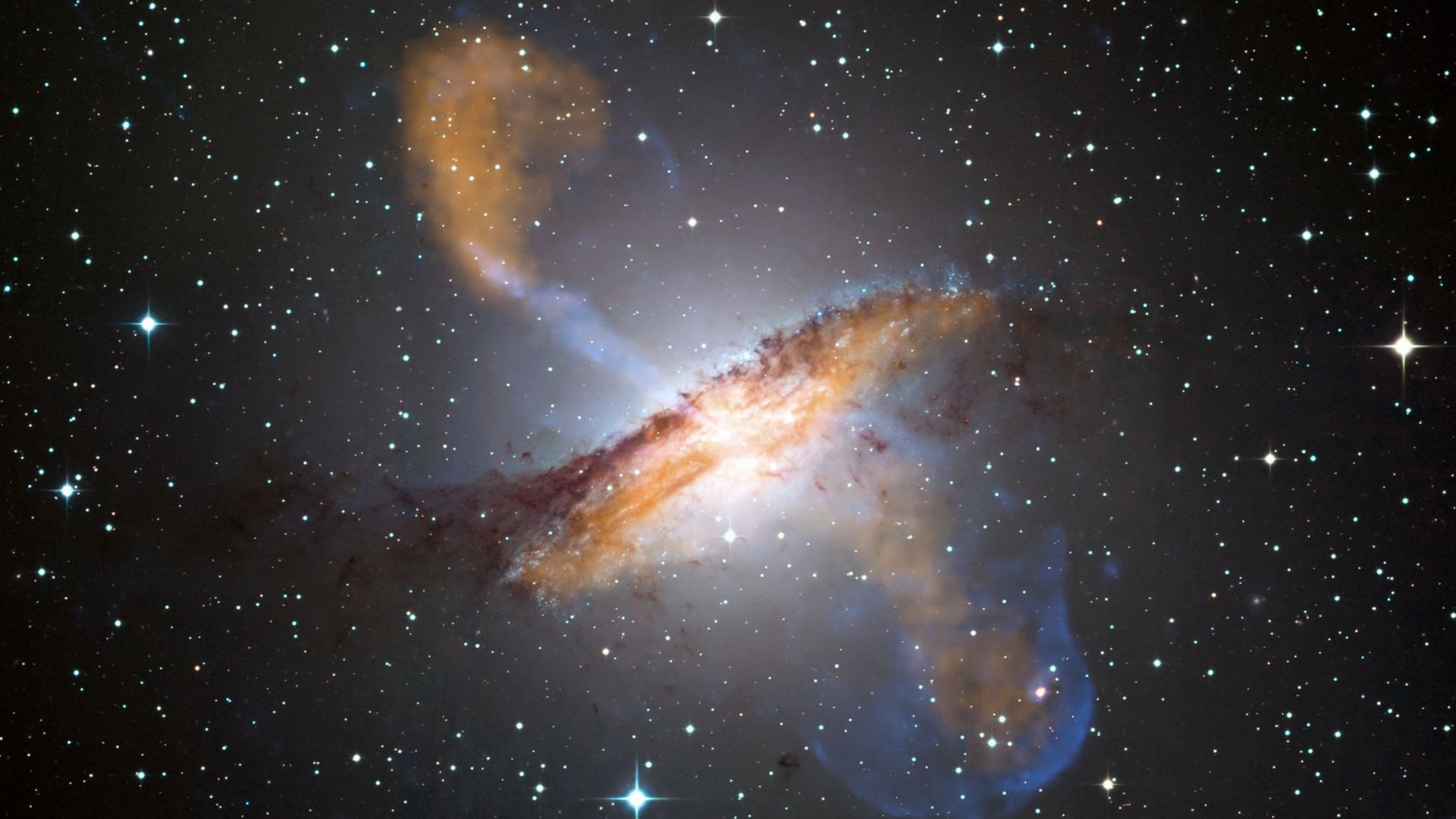 This image of Centaurus A shows a spectacular new view of a supermassive black hole's power. Jets and lobes powered by the central black hole in this nearby galaxy are shown by submillimeter data (colored orange) from the Atacama Pathfinder Experiment (AP