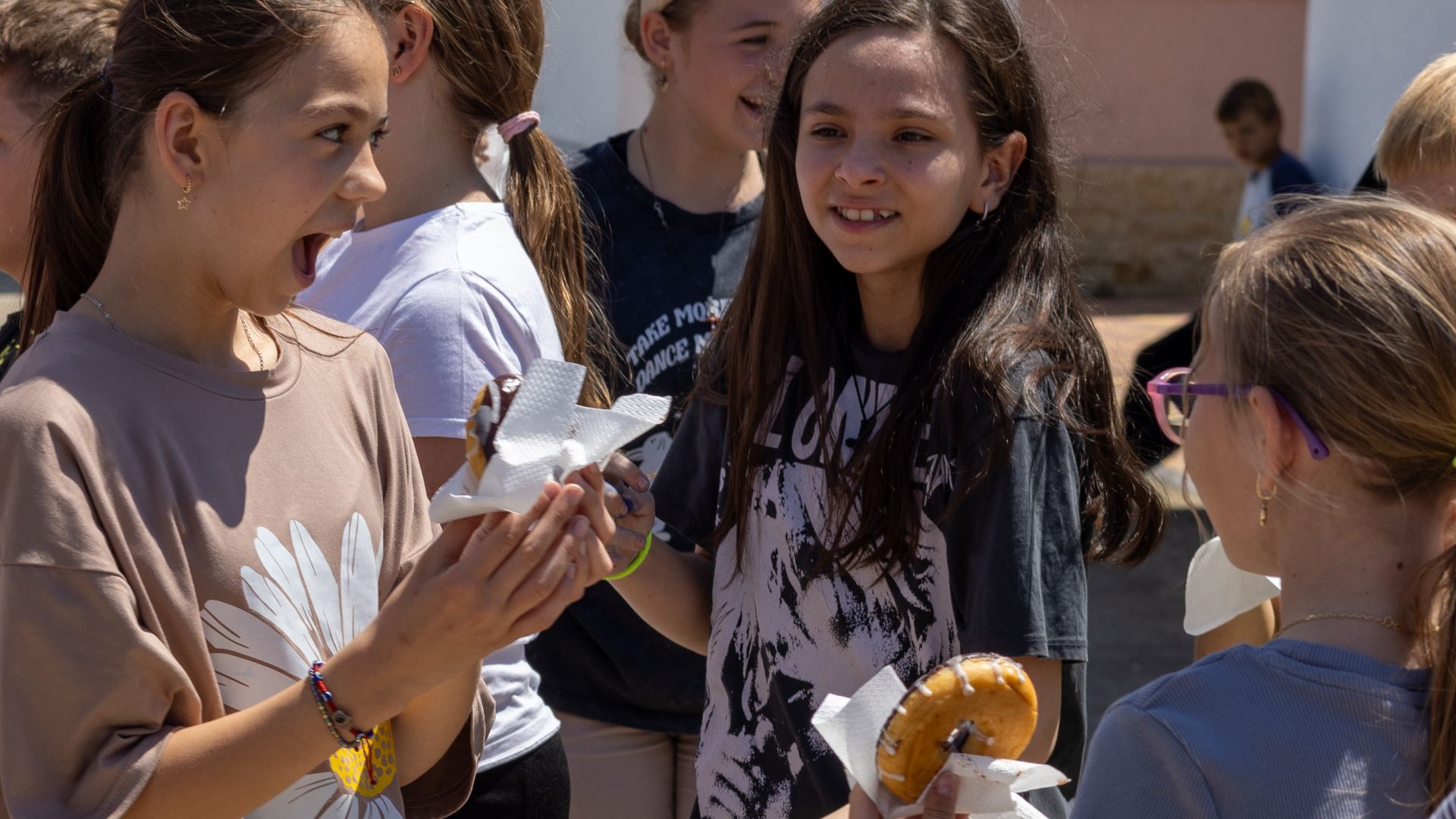 Students from Targusor Secondary School Number 1 enjoy some donuts offered by the Salvation Army on National Donut Day in Targusor, Romania, June 7, 2024. The Salvation Army created the first National Donut Day in 1938 in Chicago as a fundraiser for those