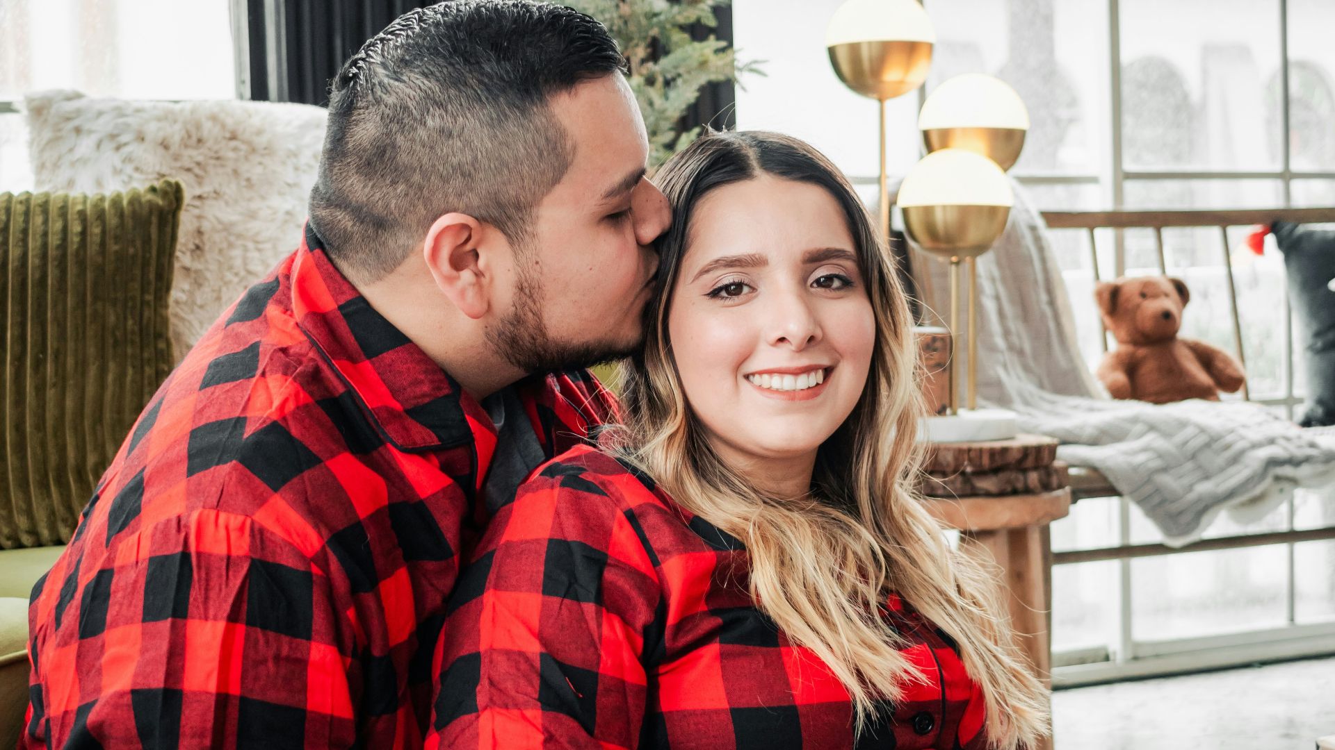a man and woman in red and black flannel pajamas
