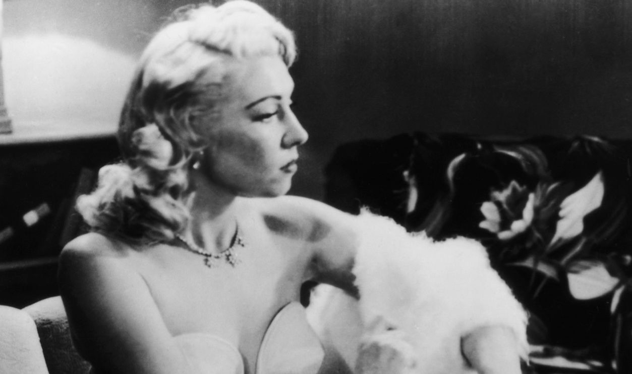 American filmmaker Edward D. Wood Jr. (1924 - 1978) watches actress Dolores Fuller remove her white angora sweater in a still from the film 'Glen Or Glenda', 1953.