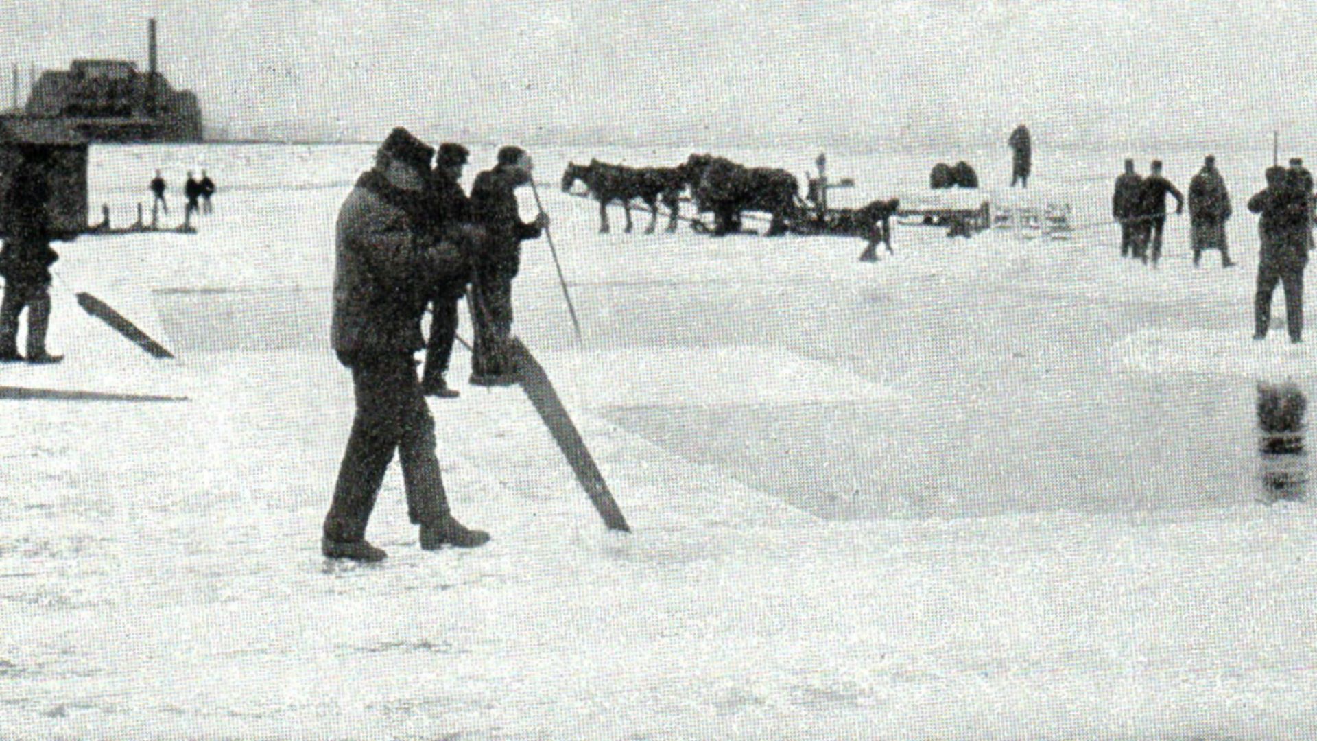 After the ice has been cut nearly through with the plow the rest of the work is done with a saw, one end of which runs down into the water. After the ice cakes are sawed out by one set of men another set pry them apart with crowbars, while a third set flo