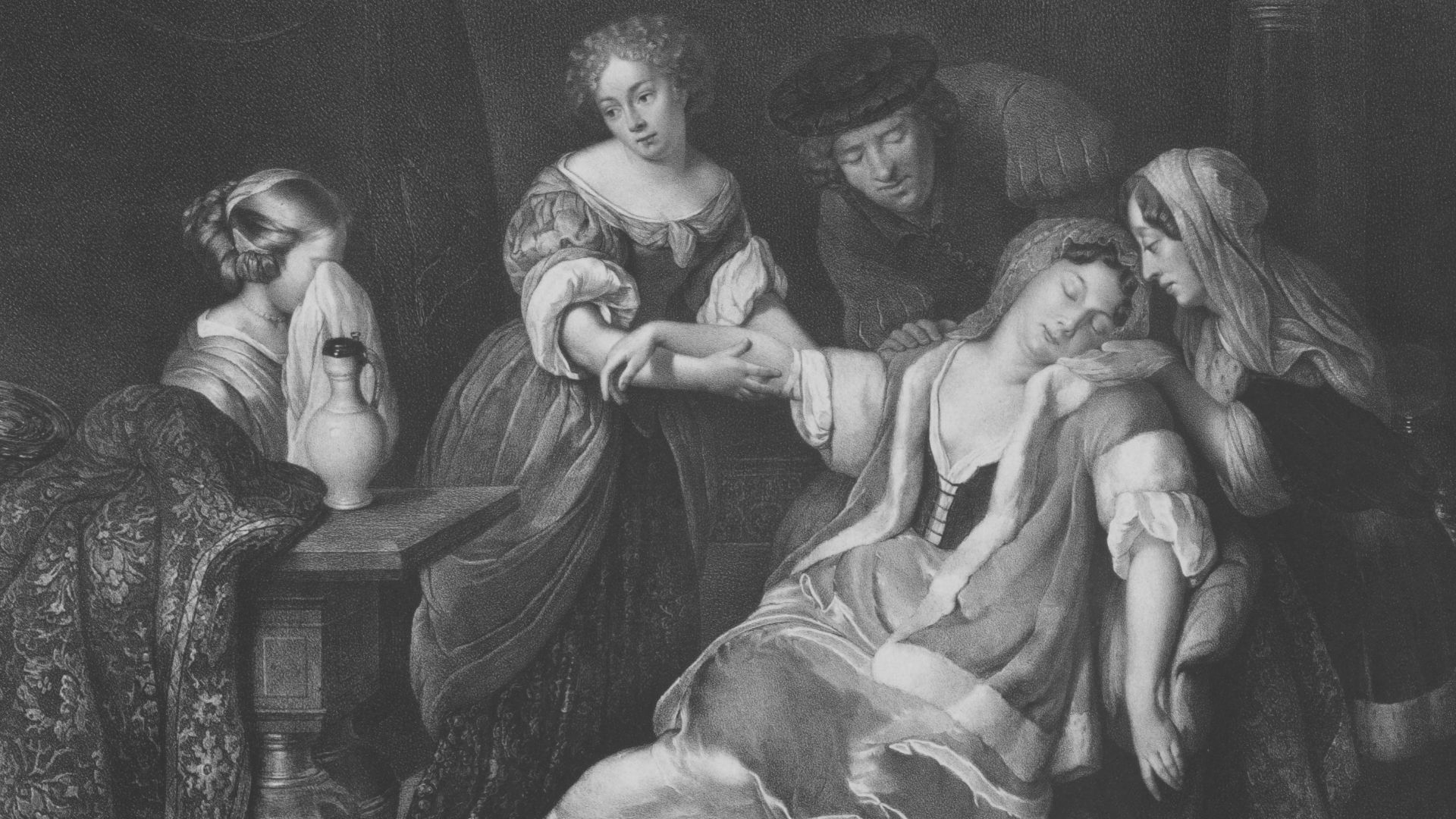 A group of people attending to a woman lying down.