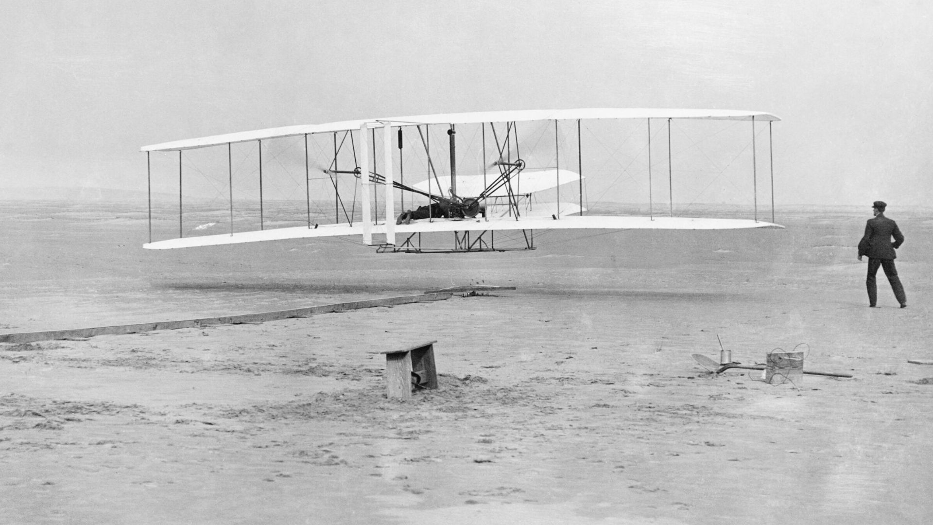 The Wright Brothers
The Wright Flyer airborne during the first powered flight at Kitty Hawk, North Carolina, United States of America, 17 December 1903.  Orville Wright is the pilot while Wilbur Wright runs alongside.