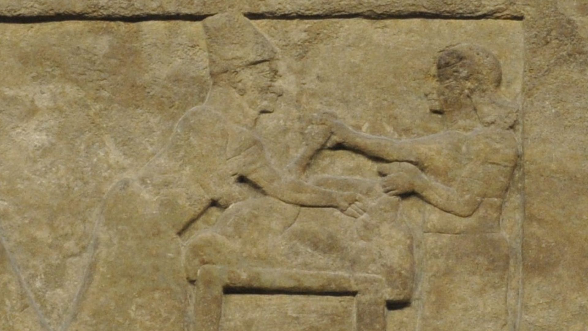 A diviner and his assitant preparing a sacrificial animal ofr purpose of divination (hepatoscopy or extispicy). Detail of a relief from the North-West Palace of Nimrud, 9th century BC.