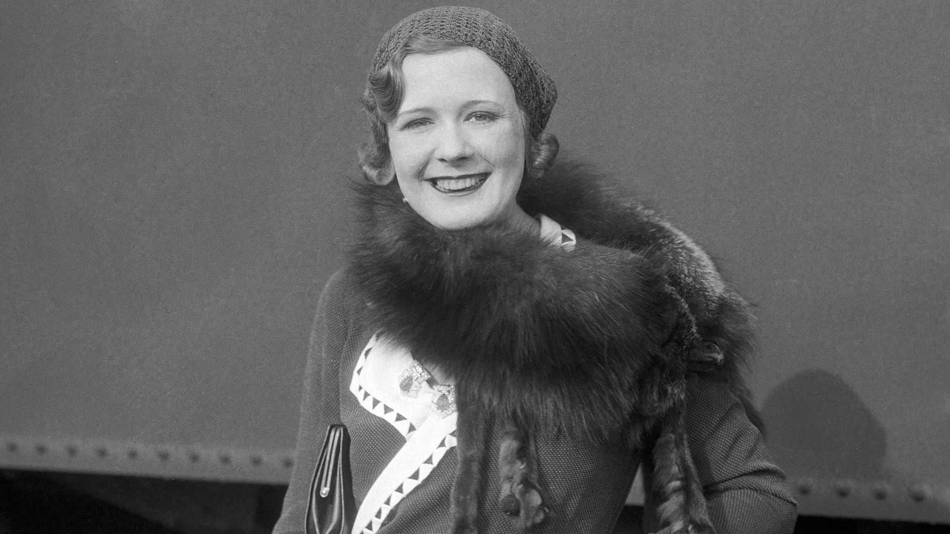 Marilyn Miller, popular Broadway actress of the 1920s and 1930s, smiles for the camera as she sets off on a trip.