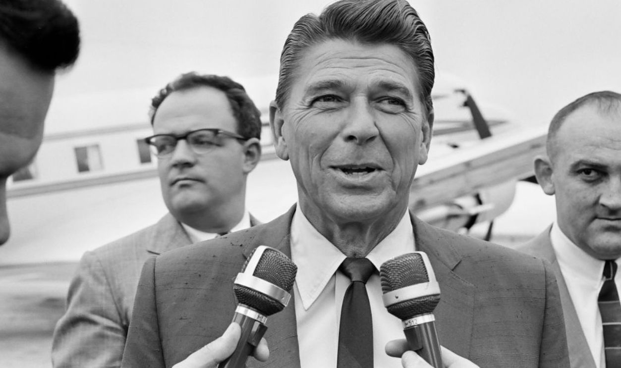 OAKLAND, CALIFORNIA - JUNE 6: Actor Ronald Reagan is interviewed by members of the press upon his arrival at the Oakland Airport on June 6, 1966 during a campaign stop in his bid to become governor or California. 