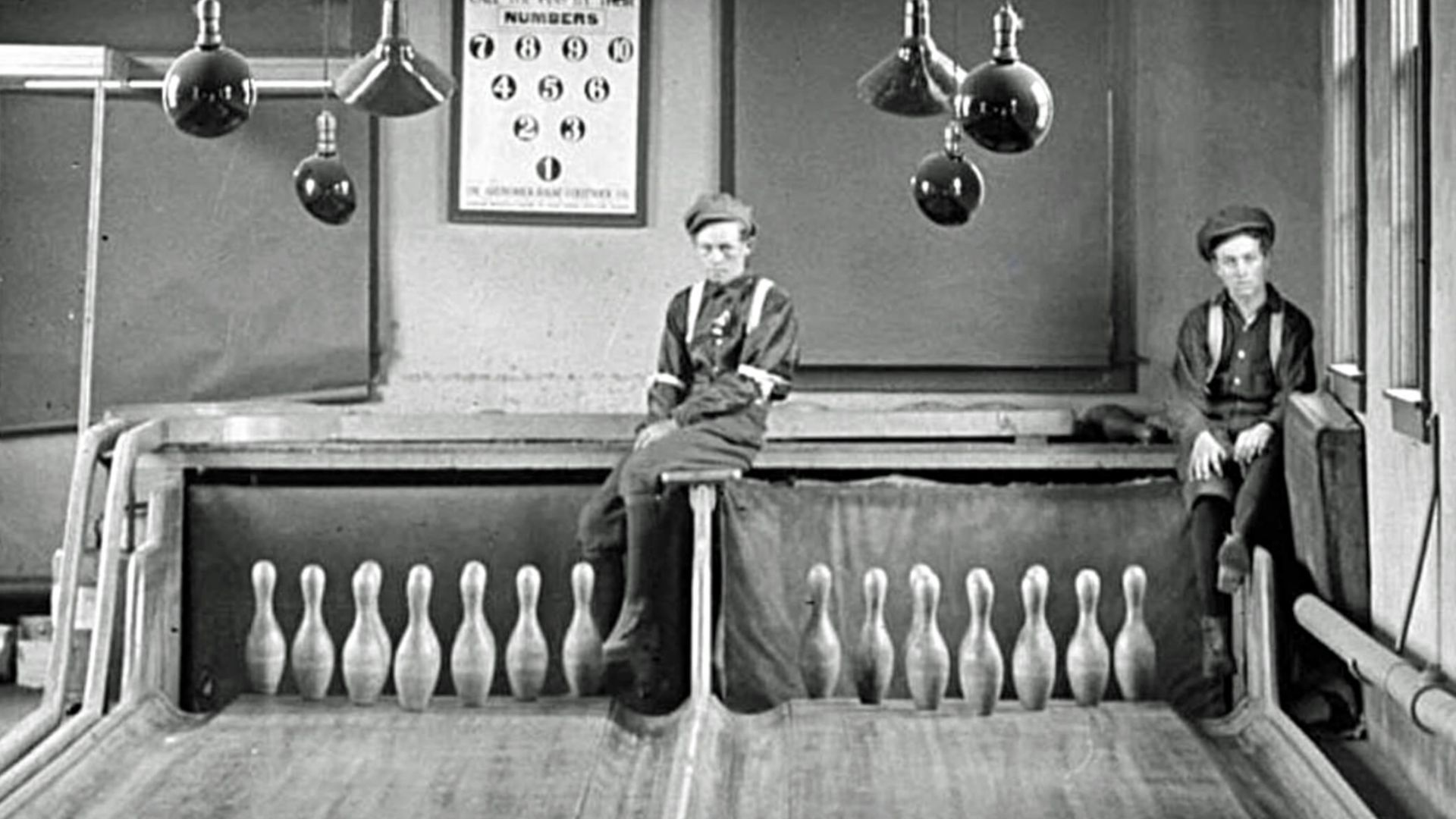 Two pinboys (human pinsetters)
Signs say: