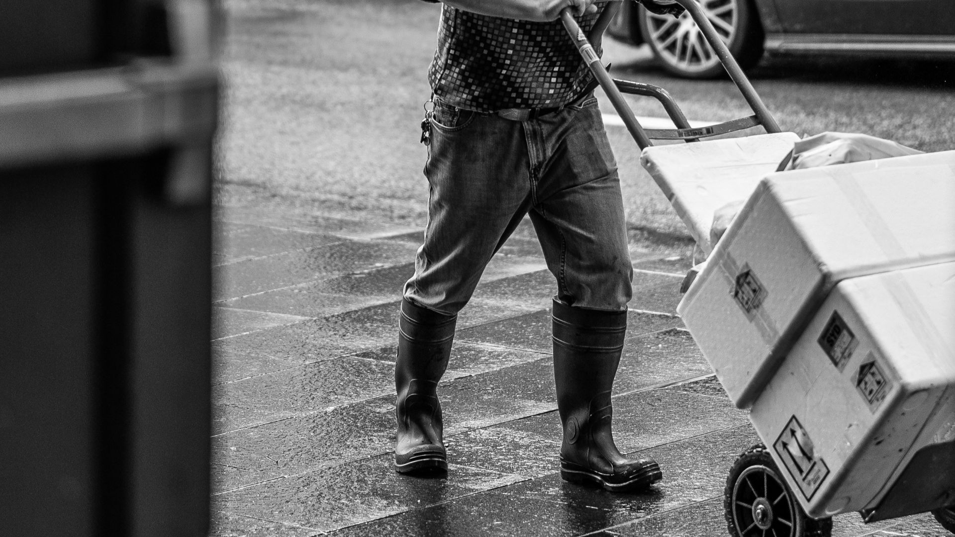 man pushing hand truck