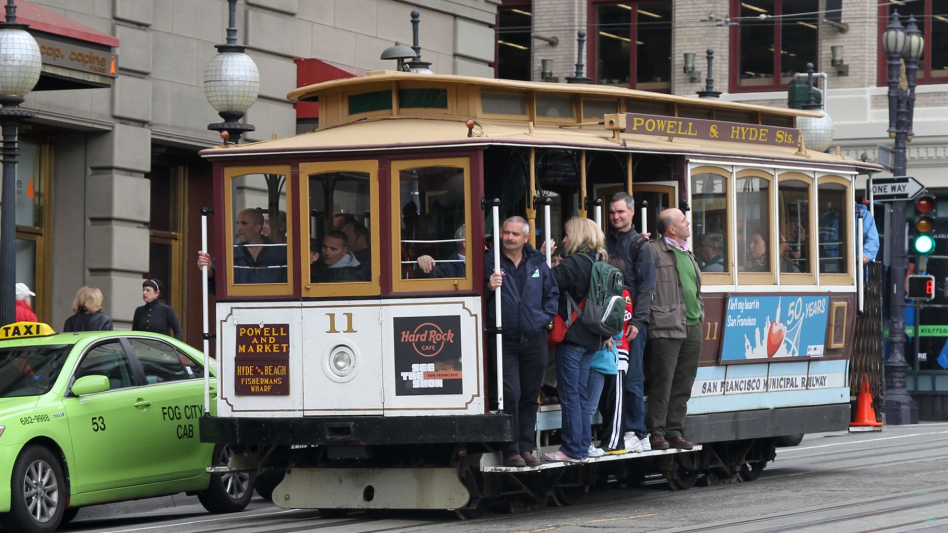 San Francisco cable car number 11 on Powell St near the corner of Post St alongside Union Square Park. San Francisco, California, USA.