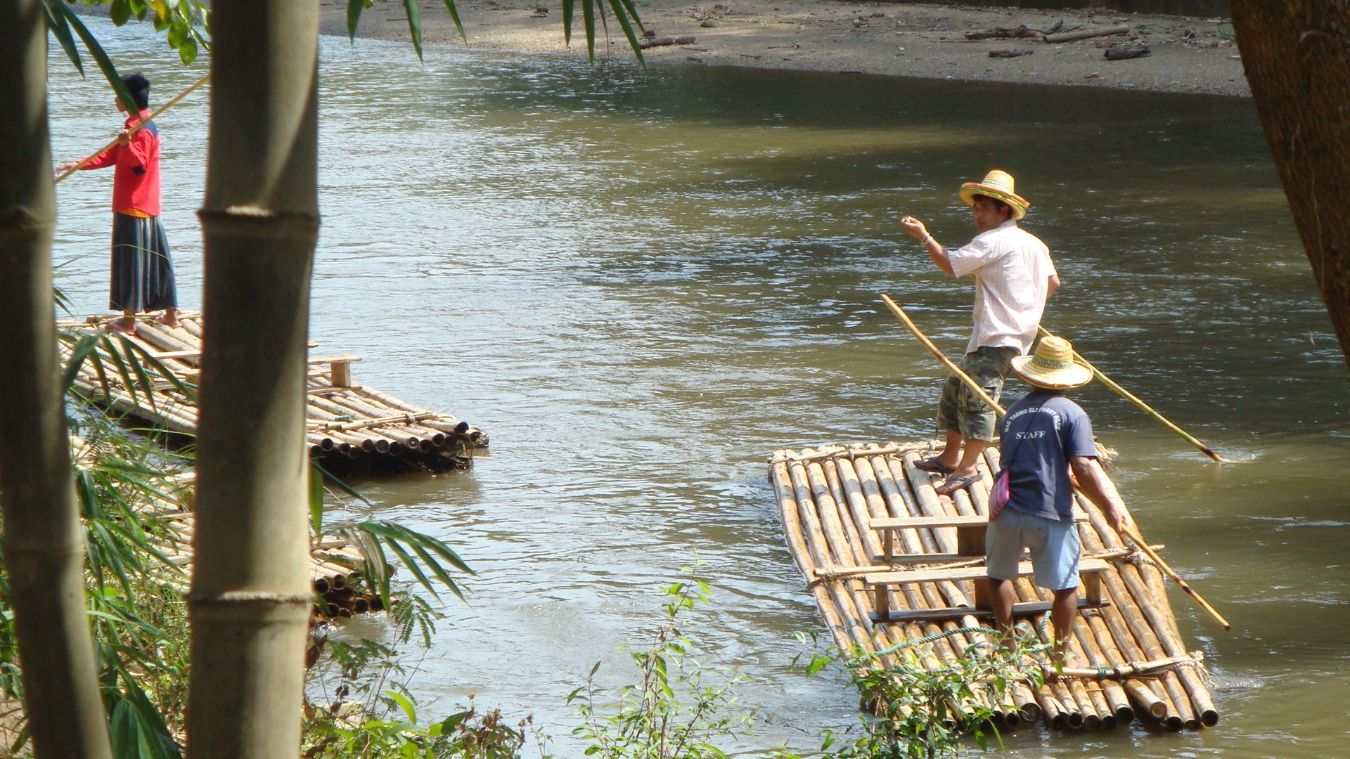 People in Thailand using bamboo raft as a mode of transportation
