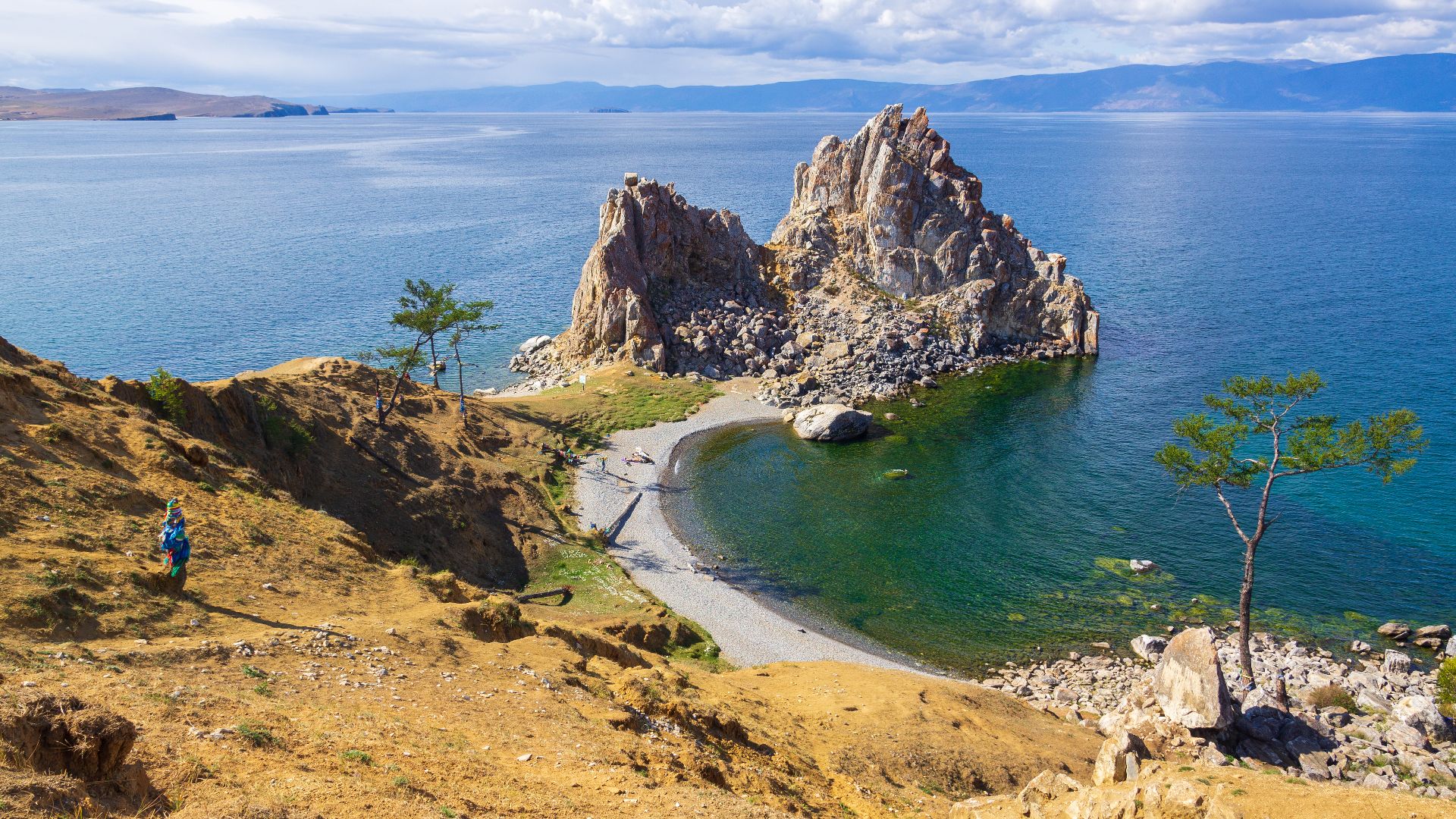 Cape Burhan with Shaman Rock, Shamanka Rock. The rock formation is made of white marble, dolomite, limestone, with inclusions of garnet, quartz and graphite. It is of great importance in the history of Siberian and Buryat shamanism and Tibetan Buddhism. O