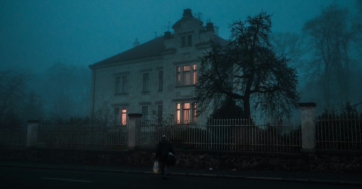 person walking towards house