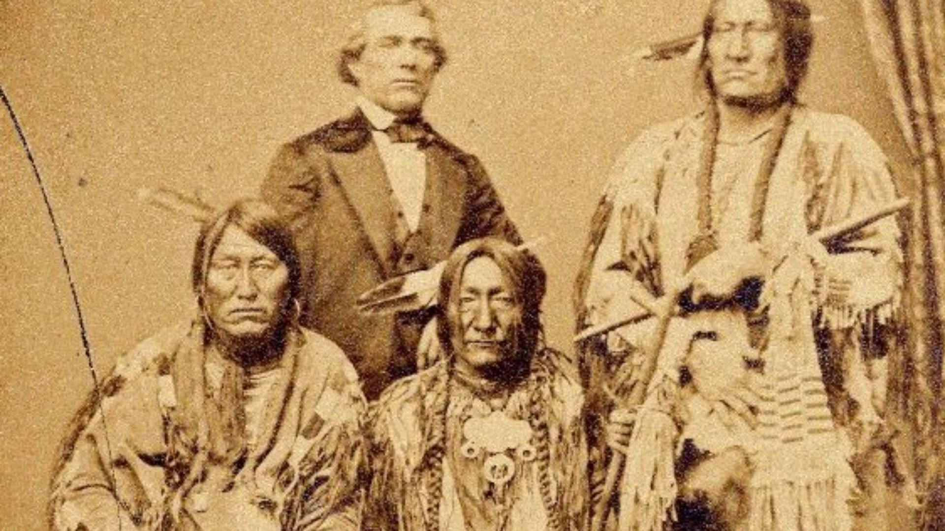 Studio photograph of three Cherokee chiefs -- Standing in the Water (Mahpevame'ehne'e), War Bonnet, and Lean Bear -- along with an interpreter. Albumen print, photographed at Leavenworth, Kansas, in 1863 by the American photographer John H. Fitzgibbon. Co