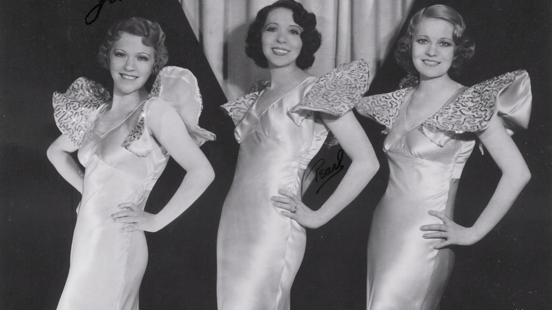 Three x Sisters publicity photo with an additional note to their hair dressing studio. Circa mid 1930s.