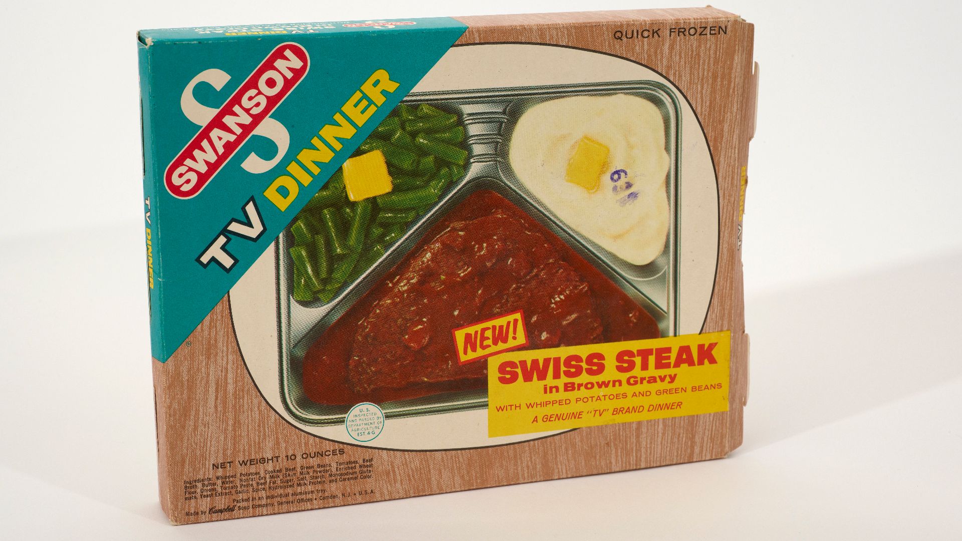 Swanson TV Dinner box and tray. The cardboard box features the Swanson logo and an image of Swiss Steak in brown gravy with whipped potatoes and green beans.