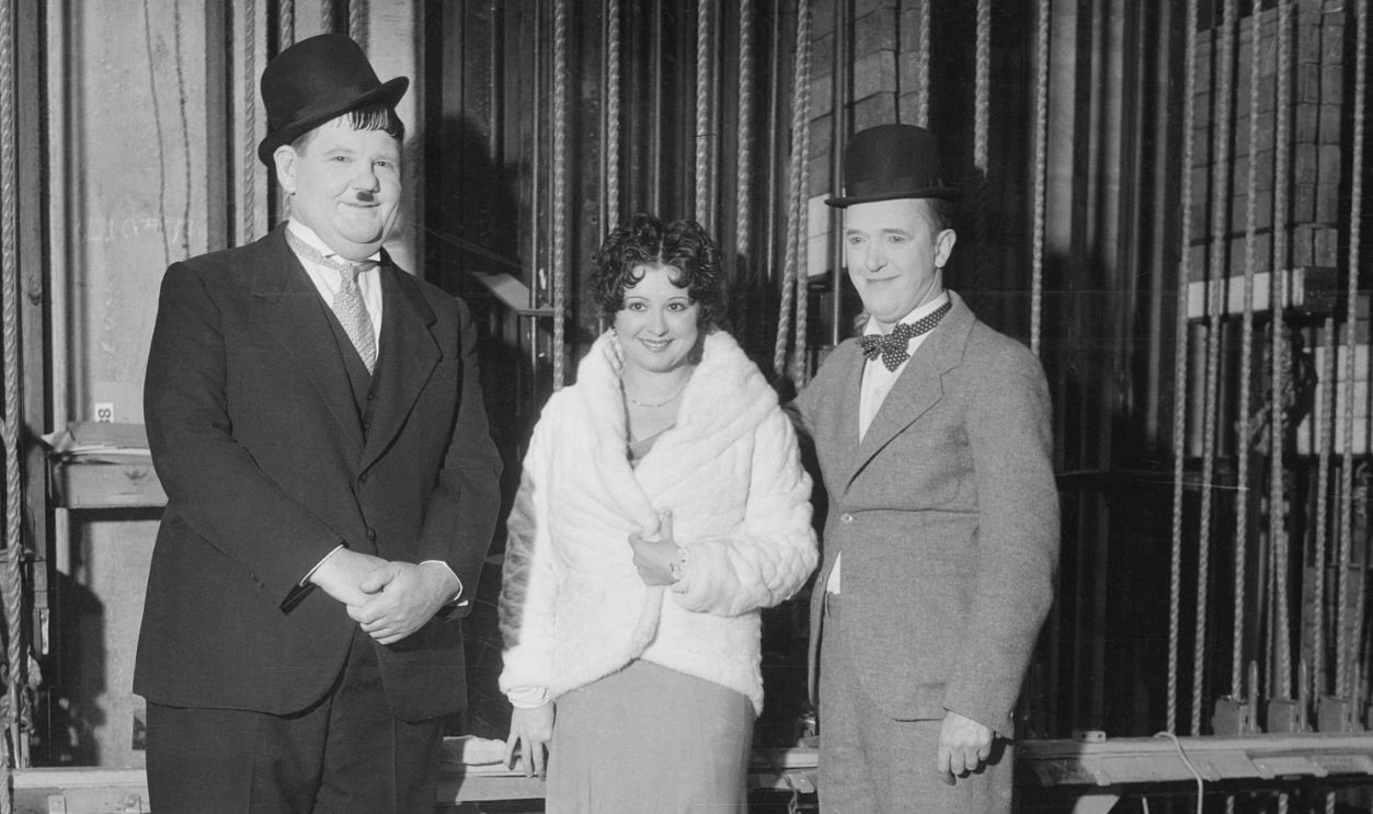 (Original Caption) Film folk at Benefit Show. Oliver Hardy, Helen Kane, Boop originator; and Stan Laurel (right) are seen here at the Christmas Benefit Show, staged by a Los Angeles newspaper, at the Shrine Civic Auditorium in Los Angeles. Radio, screen, and stage luminaries attended and participated in the festivities.